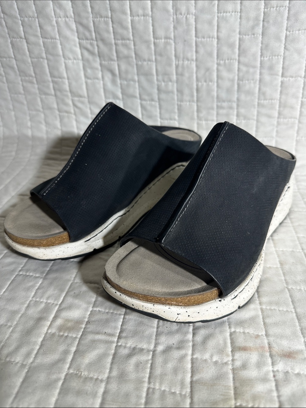 Bionica Oceana slip-on wedge sandals in black with a white speckled sole